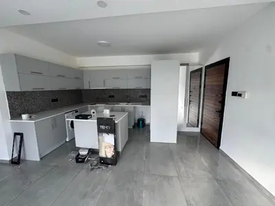 an empty kitchen with white cabinets and a floor at 3 bed flat in Nicosia in Nicosia
