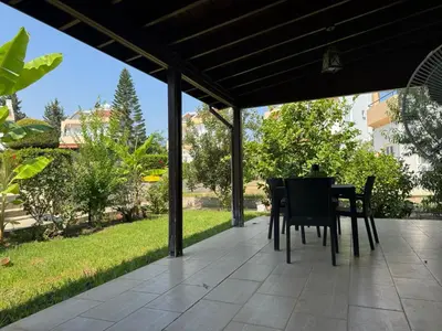 a patio with black chairs and a table on a patio at 3 bedroom Villa in Kyrenia, 2 minutes away from the beach! in Strovolos