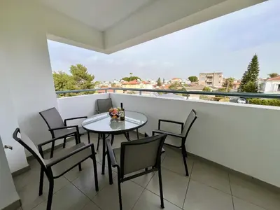 a table and chairs on a balcony with a view at STAY Sun Line Apartment in Nicosia