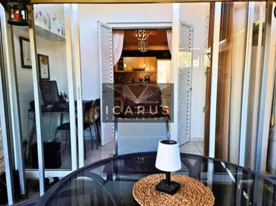 a table with a lamp on a glass table in front of a store at Seana Kapparis Apartment with Private Pool in Aglantzia