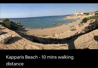 a view of a beach with people in the water at Seana Kapparis Apartment with Private Pool in Aglantzia