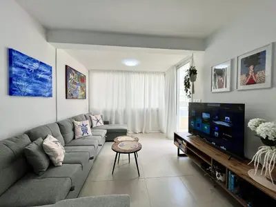 a living room with a couch and a flat screen tv at STAY Blue House in Larnaka