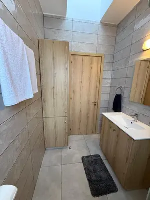 a bathroom with a sink and a mirror at Ocean Breeze 2BR House in Paralimni