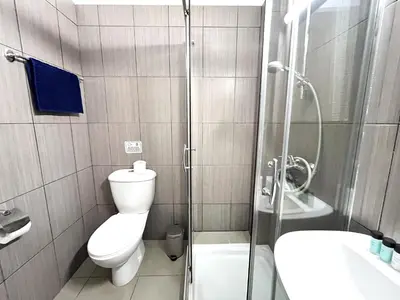 a bathroom with a shower and a toilet and a sink at STAY Tropical Apartment in Protaras