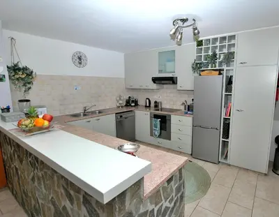 a kitchen with white cabinets and a bowl of fruit on the counter at Villa Acanthus in Pissouri