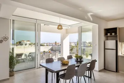a kitchen and dining room with a table and chairs at Protaras Hestia Seaside Villa A6 in Protaras