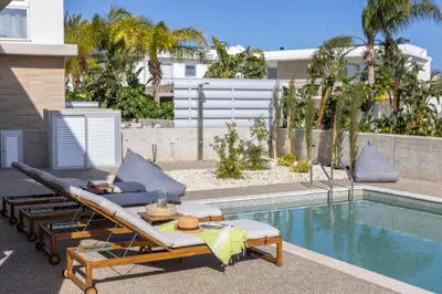 a swimming pool with a patio furniture next to a swimming pool at Protaras Hestia Seaside Villa A6 in Protaras