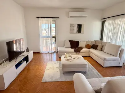 a living room with a couch and a tv at The Perfect Lefkosa Stay - Zahra & Dereboyu & Ledra in Nicosia