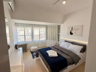 a bedroom with a large bed and a window at The Perfect Lefkosa Stay - Zahra & Dereboyu & Ledra in Nicosia