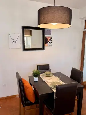 a dining room table with chairs and aendant light at The Perfect Lefkosa Stay - Zahra & Dereboyu & Ledra in Nicosia