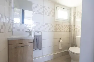 a bathroom with a sink and a toilet at Living the View in Protaras