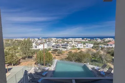 a house with a swimming pool and a view of a city at Living the View in Protaras
