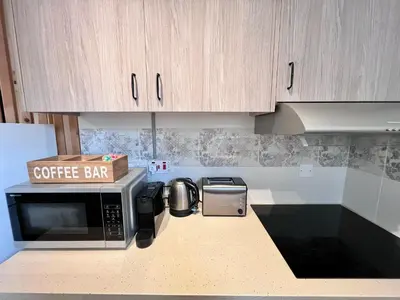 a kitchen with a coffee bar on top of a microwave at Monte Napa Moments in Ayia Napa