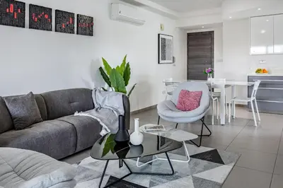 a living room with a couch and a table at Vasileos Konstantinou Modern 2BR City Apartment with Balcony in Limassol