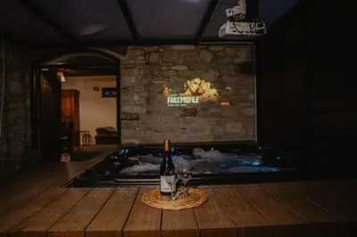 a bottle of wine sitting on a table in a room at Stonehouse in Monagri
