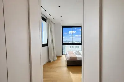 a bedroom with a bed and a large window at Stasikratous Residence - 10th Floor Gym in Nicosia