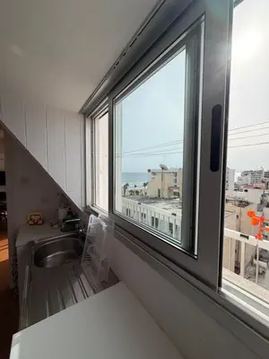 a kitchen with a sink and a large window at SeaScape Eight in Larnaka