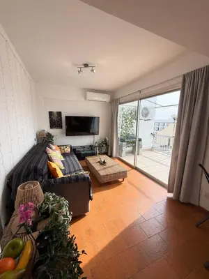 a living room with a couch and a tv at SeaScape Eight in Larnaka