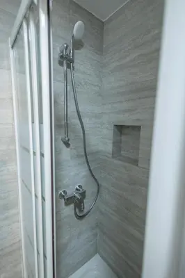 a shower with a shower head in a bathroom at Studio in Limassol Coast in Limassol