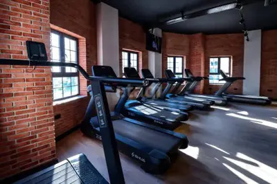 a row of treadmills in a gym with a brick wall at Sea view Remus Family 2 bdr apartment in Nicosia