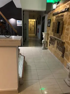 a hallway with a stone wall and a tile floor at Kipros Accommodation in Nicosia