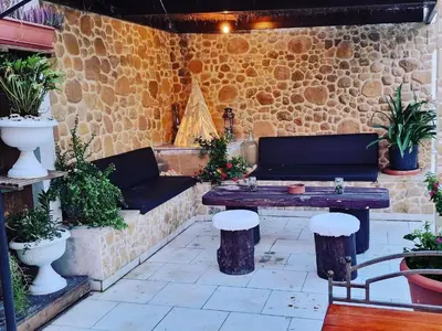 a patio with a couch and a table and some plants at Kipros Accommodation in Nicosia