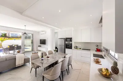 a kitchen and dining room with a table and chairs at Protaras Sol e Mar Villa 2 in Protaras
