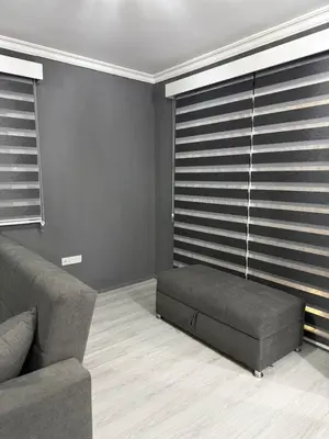 a living room with a couch and window blinds at Royal Sun Comfortable Villa in Larnaka