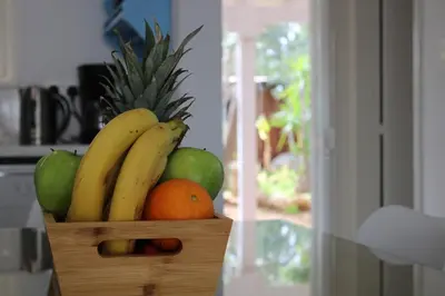 a wooden basket filled with fruit in a kitchen at Andreotis Garden in Protaras
