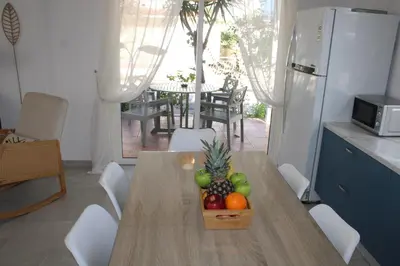 a kitchen with a table with a bowl of fruit on it at Andreotis Garden in Protaras