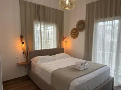 a bedroom with a bed with two towels on it at Andreotis Garden in Protaras