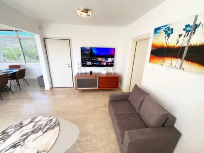 a living room with a couch and a tv at Marina Sea Breeze Apartment, Sleeps 8, Free Wi-Fi in Limassol