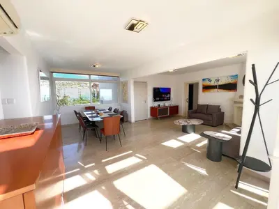 a living room with a table and a dining room at Marina Sea Breeze Apartment, Sleeps 8, Free Wi-Fi in Limassol