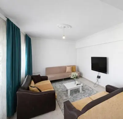 a living room with two couches and a tv at Kyrenia City Center Apartment in Kambia