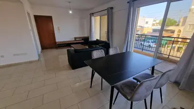 a living room with a black table and chairs at Limassol Great in Limassol
