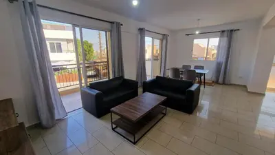 a living room with two chairs and a table at Limassol Great in Limassol