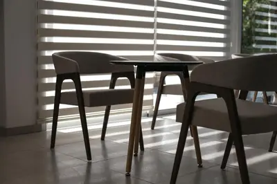 two chairs and a table in front of a window at Flora Maria Hotel in Ayia Napa