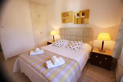 a bedroom with a bed with two towels on it at The Love Nest in Pissouri