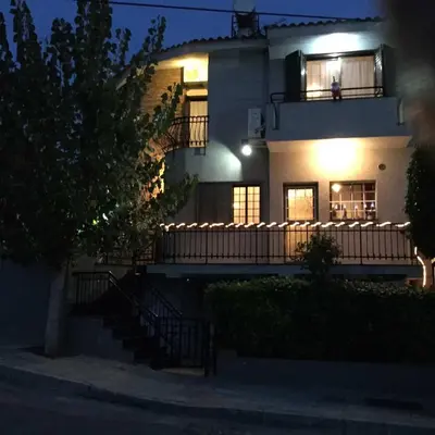 a large white house with a balcony at night at Nikola's House in Limassol