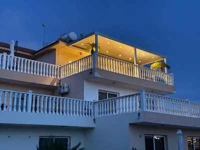 a building with a balcony with a large window at Nissi Golden Sands Paradi in Ayia Napa