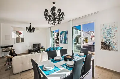 a dining room with a table and chairs at Seaspray in Protaras