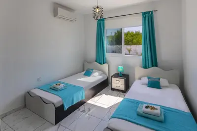 a bedroom with two beds and a window at Protaras Villa Hollywood in Protaras