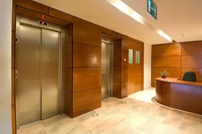 an office lobby with elevators and a desk at Ithaki Phinikoudes Apartment 307 in Larnaka