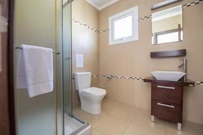 a bathroom with a toilet and a sink and a shower at Nancy Villas in Protaras