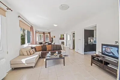 a living room with a couch and a tv at Nancy Villas in Protaras