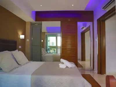 a bedroom with a large bed with two towels on it at Sofouli Suites in Nicosia