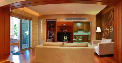 a living room with a couch and a dining room at Sofouli Suites in Nicosia