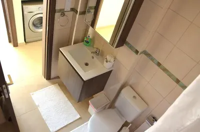 an overhead view of a bathroom with a toilet and sink at Domino Blue Apartment in Paralimni