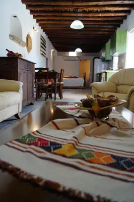 a living room with a table and a couch at Makrinari Tis Pano Geitonias in Salamiou