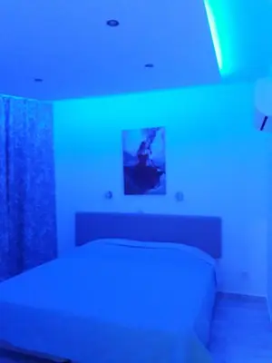 a room with a bed with a blue light at P L Sunorama Beach Garden 302 in Larnaka